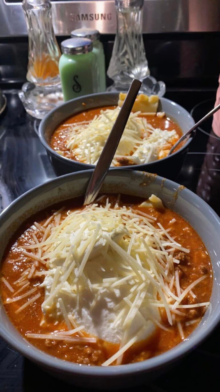 Bowl of lasagna soup topped with buttery cracker crust, bubbling in the oven—rich with beef, sausage, and herbs