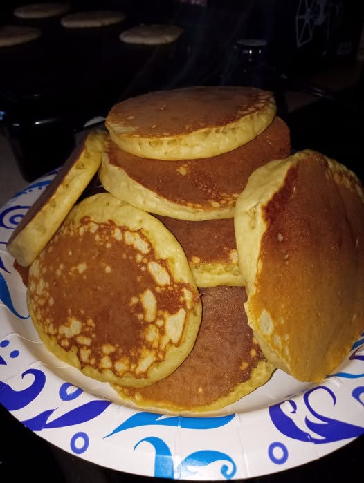 Stack of golden, fluffy homemade buttermilk pancakes on a plate, ready to serve for breakfast.